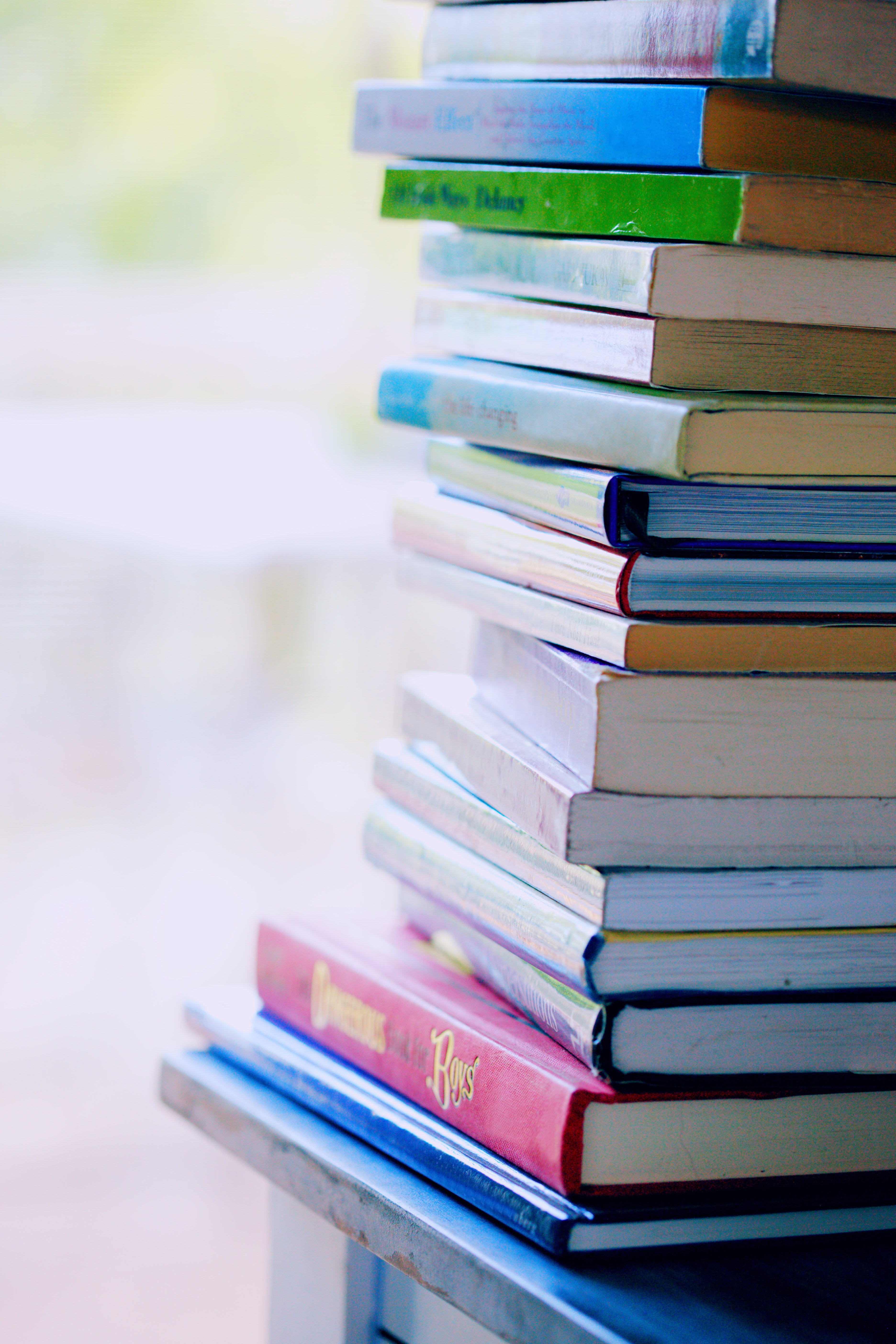 Stack of books on table, soft focus